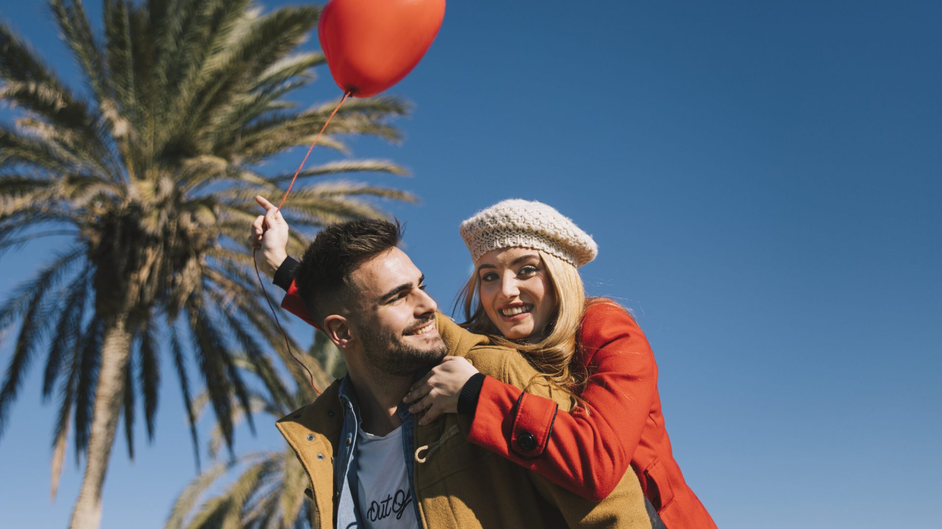 amorous-young-couple-with-balloon-shore