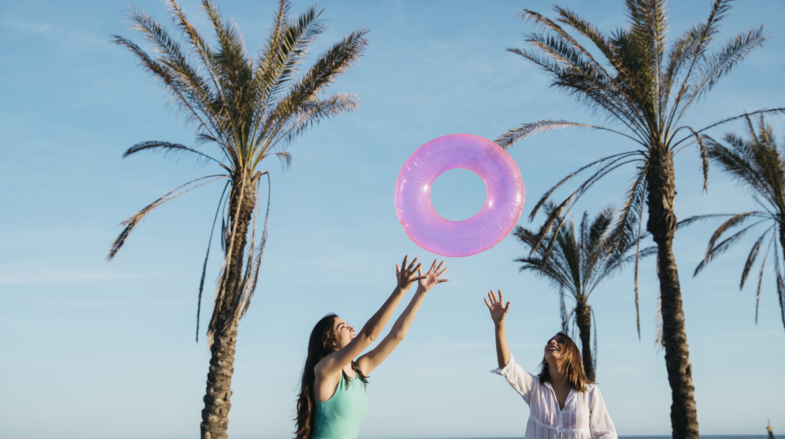 beach-summer-concept-with-joyful-women-palm-trees