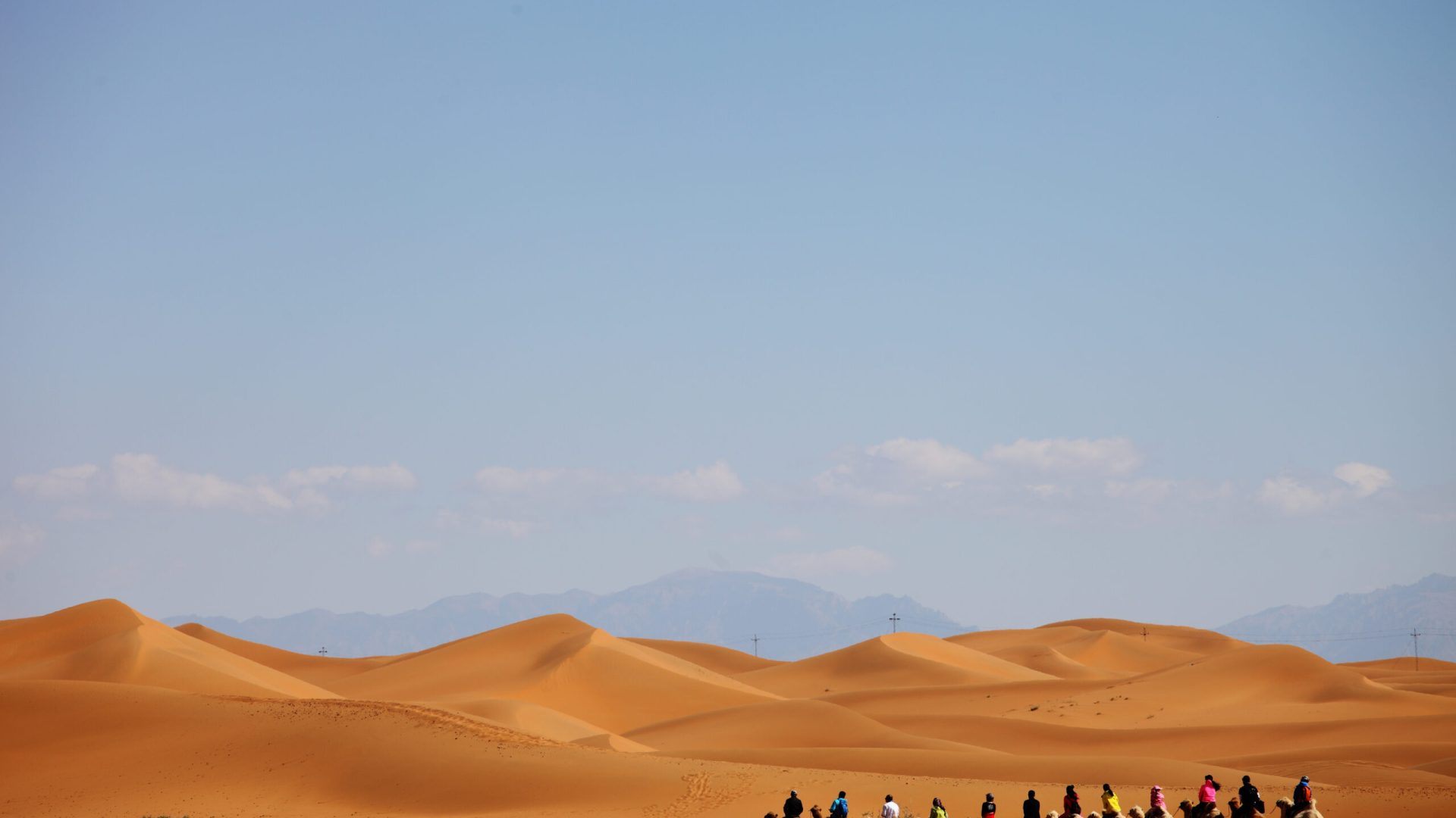 A camel caravan in a desert in Xinjiang, China