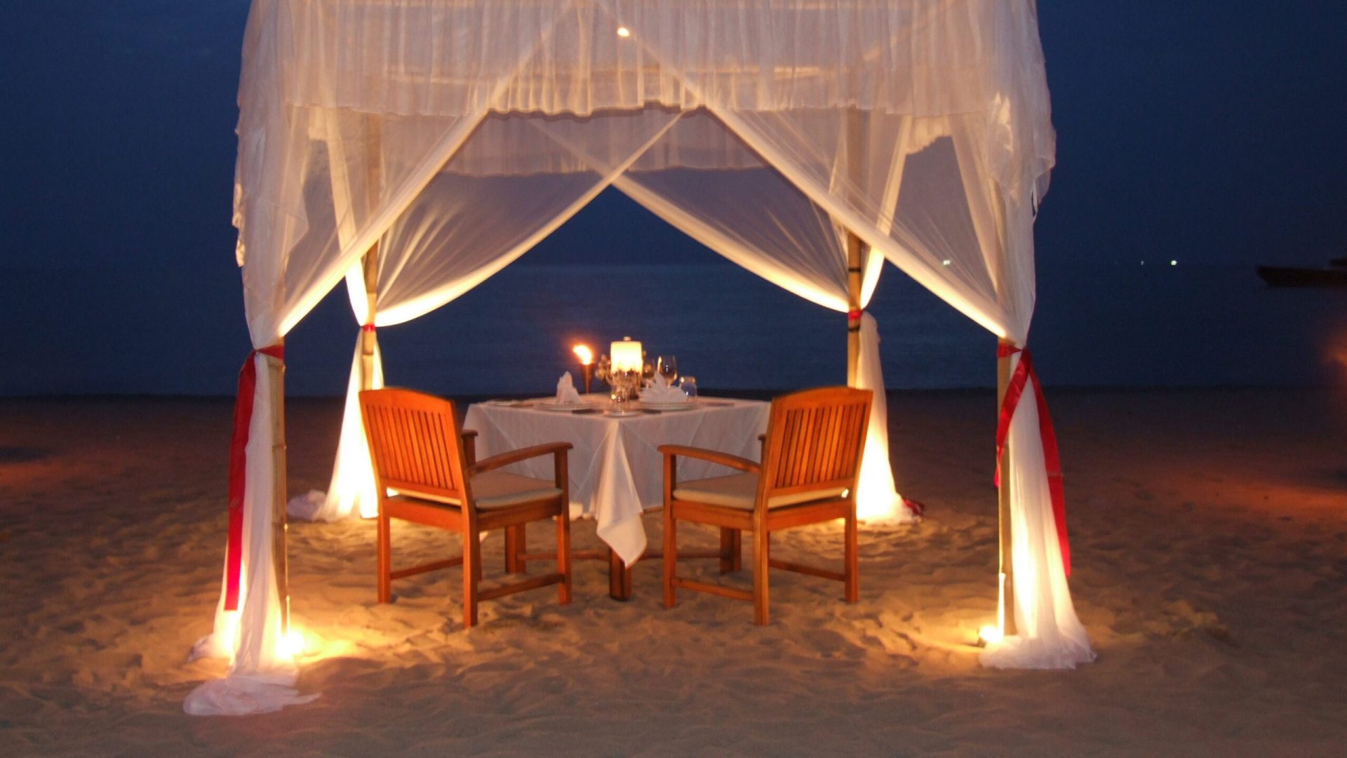 chairs-tables-beach-against-sky