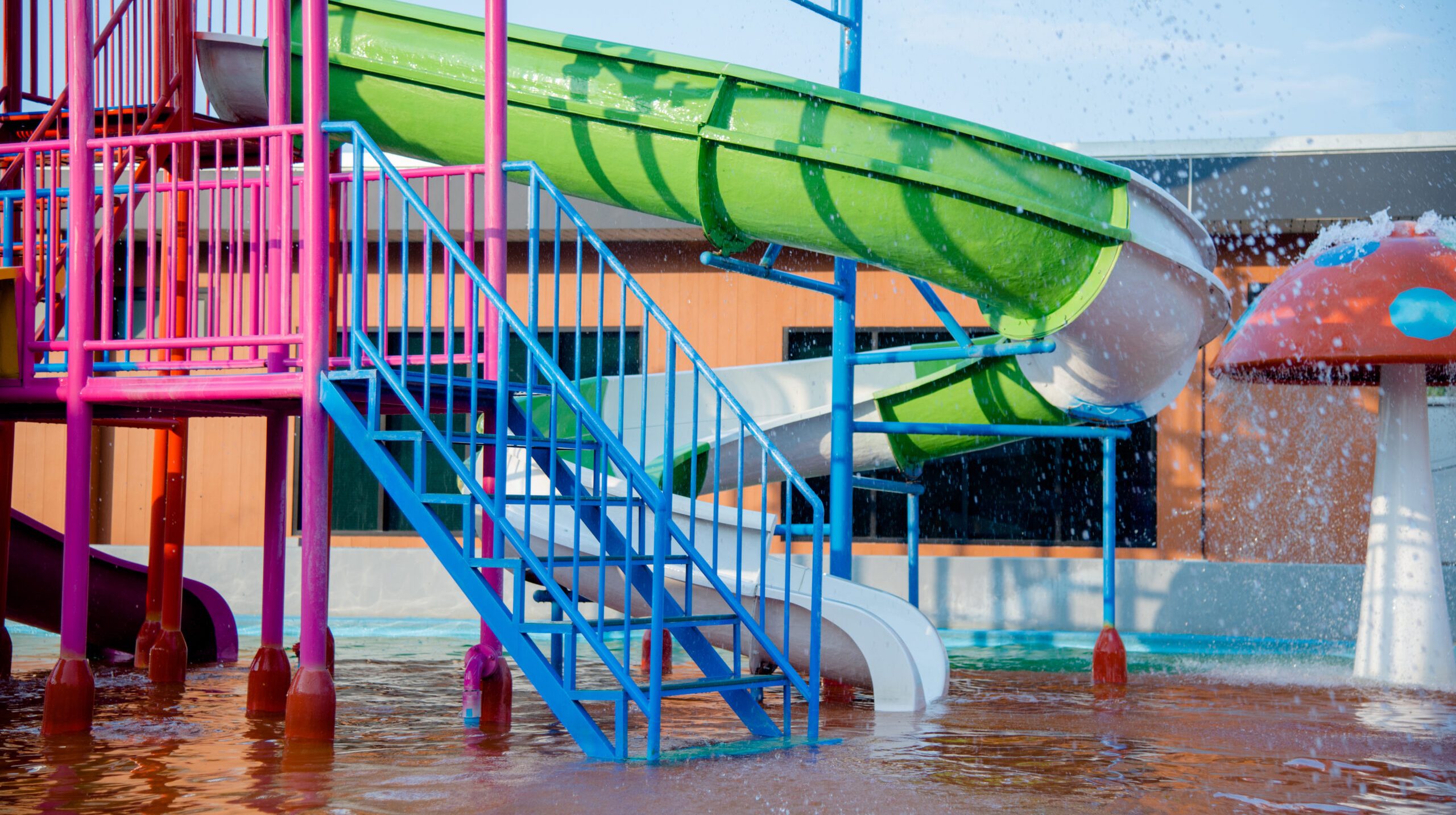 Colourful plastic slides in water park in the sunlight