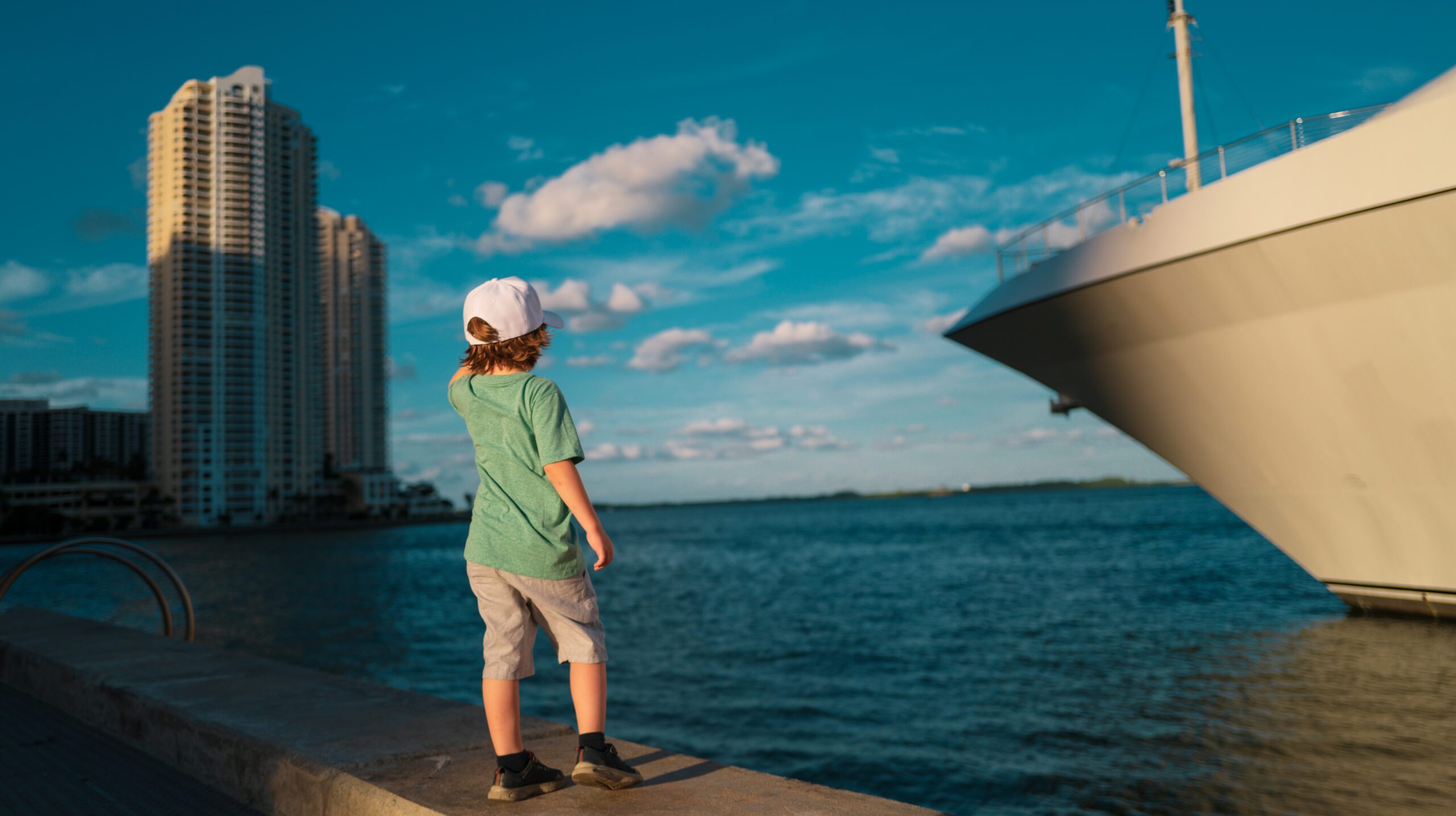 covid-19,kid with medical mask and backpack going to schooll outdoor. Adorable little girl eating ice-cream in popular area in Old Havana, Cuba. Portrait of cutiest kid outdoors on a street of Havana. I choose you. Little boy point finger on city street. Small child with stylish haircut. Little child with short blond hair. Healthy hair care habits. Hair care products. Why dont you get a haircut.