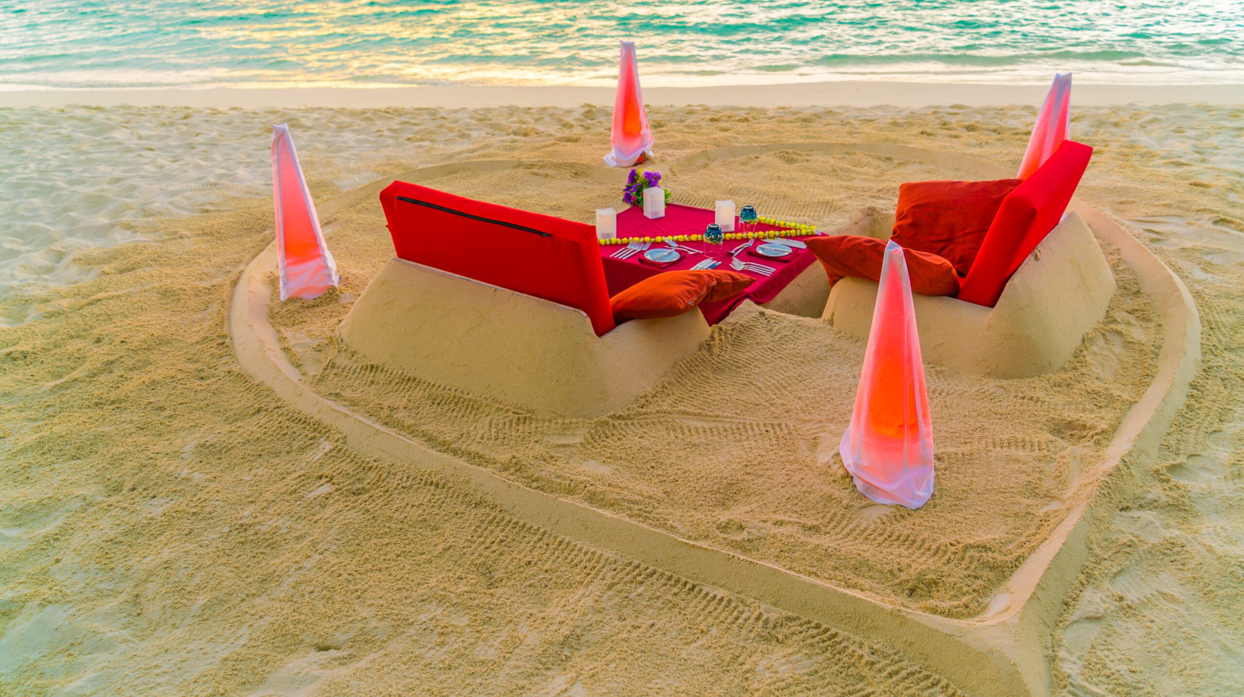 Dining table on beach at tropical Maldives island .