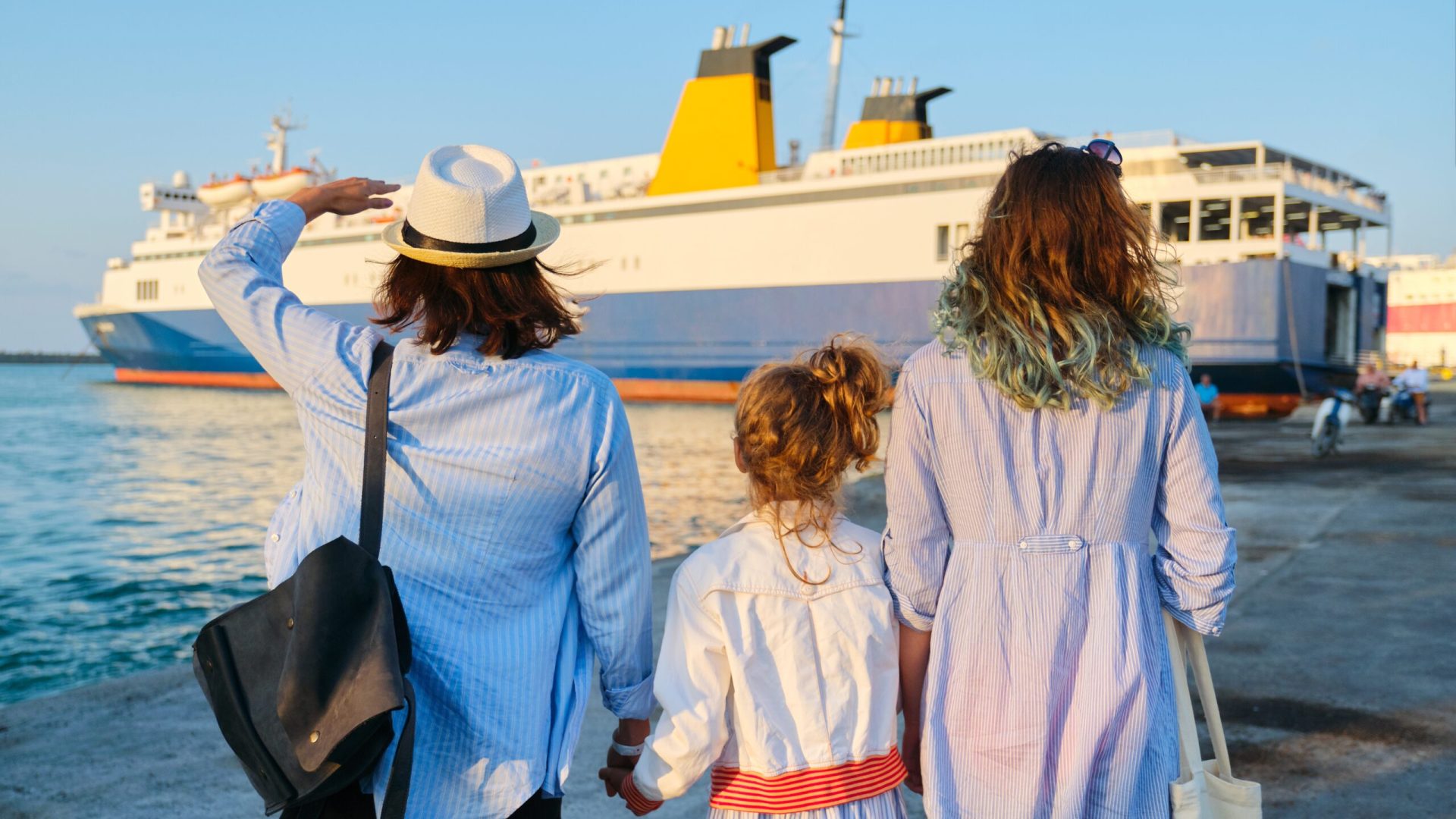 Family vacation together, mother and two daughters in seaport near ferry, summer holiday, sea transport