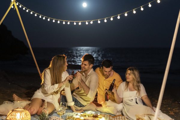 friends-night-beach-with-beer-food-scaled-rh7bt3l5qe4zhy6ujlivgjthdglrby9ajjxboh49io