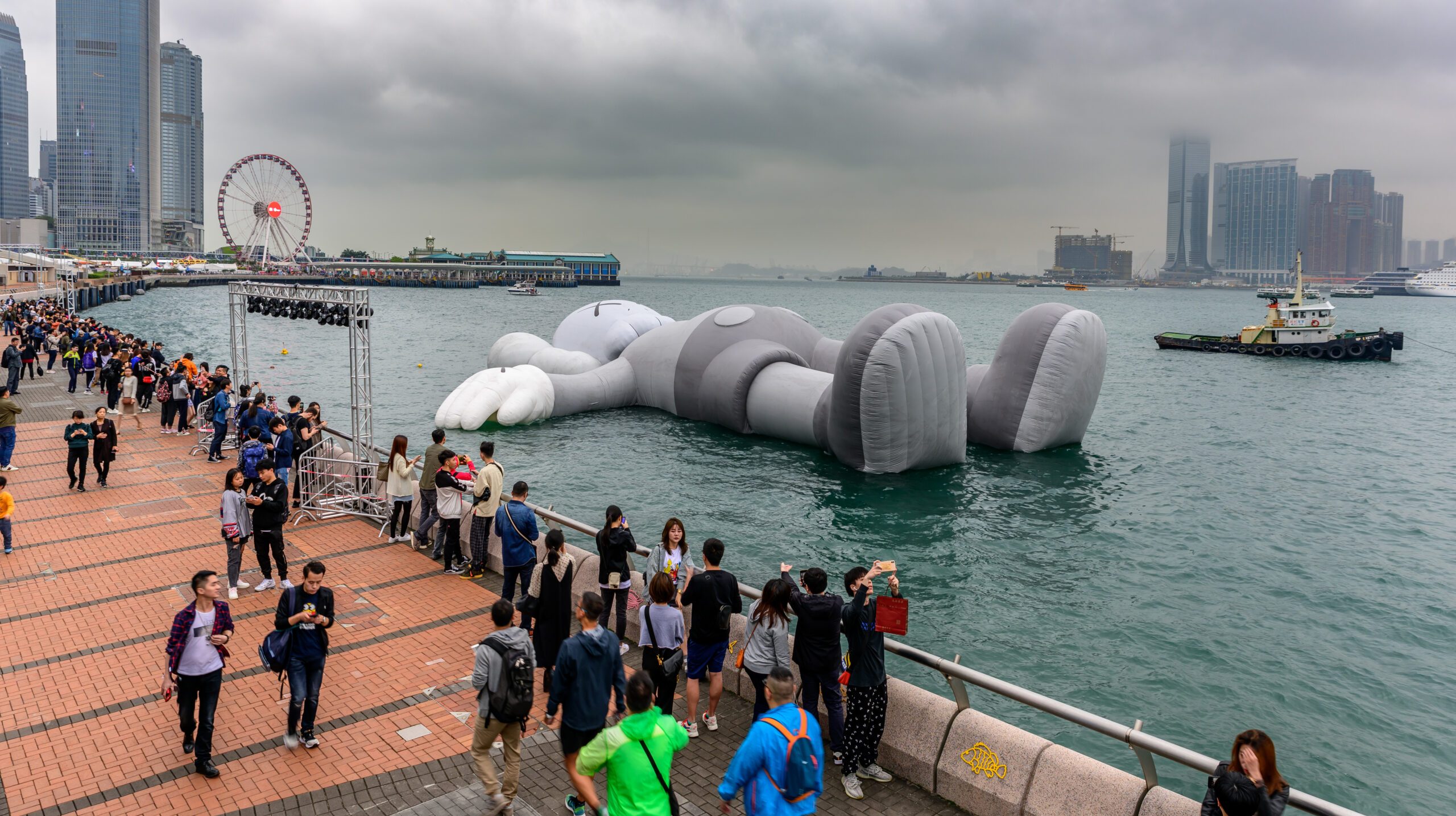 Victoria Harbour, Hong Kong - March 23, 2019 : Display ‘Companion’ of KAWS in Hong Kong. It is a big air formwork with a representative character 'COMPANION' of KAWS (real name: Brian Donnelly).