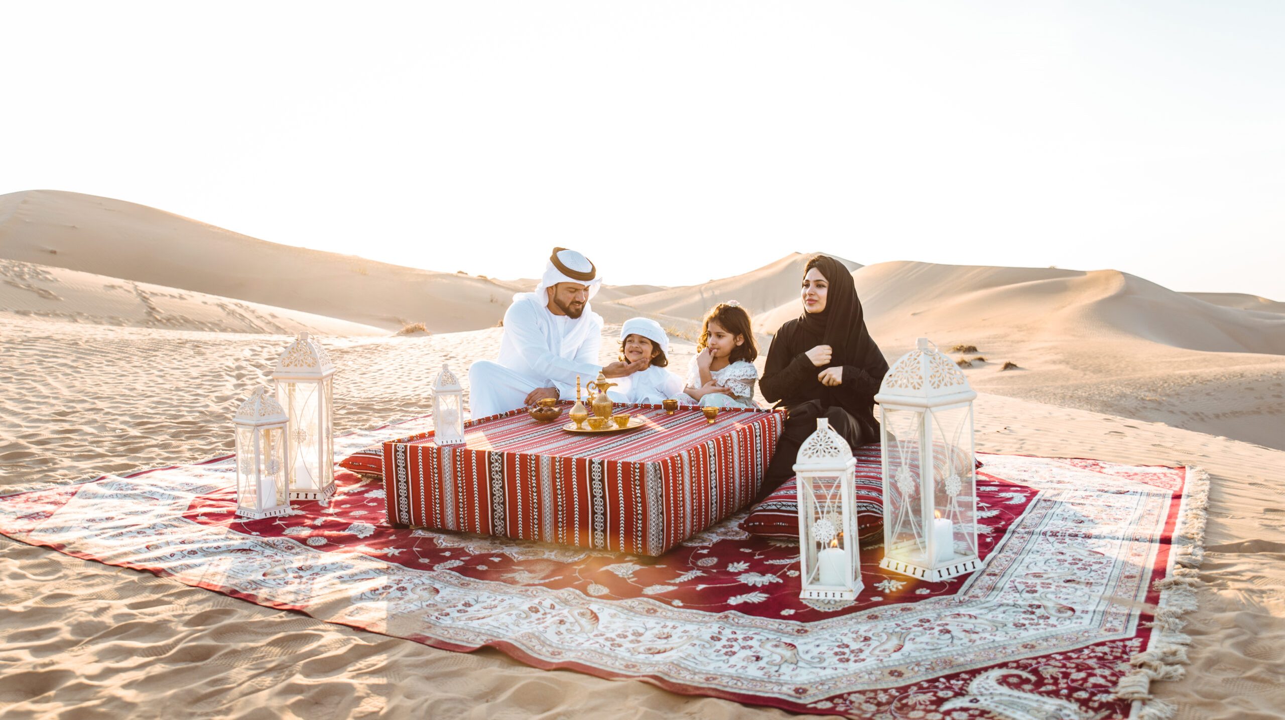 Happy family spending a wonderful day in the desert making a picnic