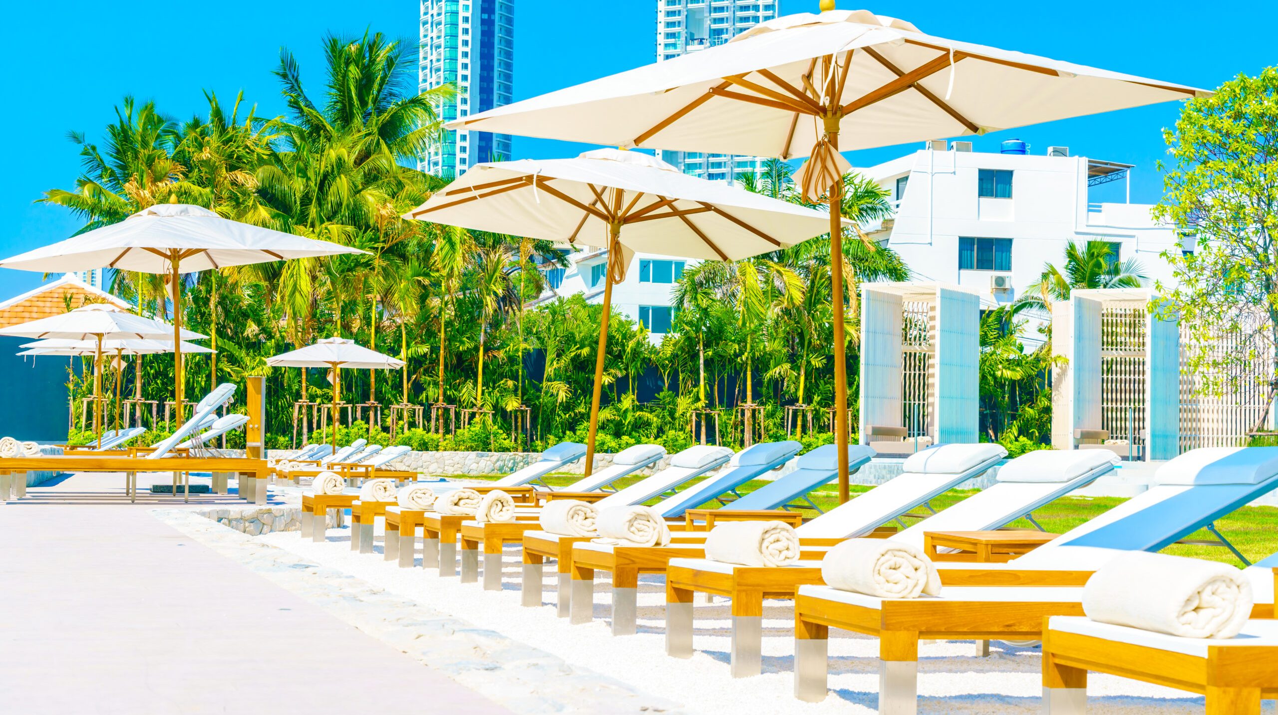 Beautiful luxury hotel swimming pool resort with umbrella and chair