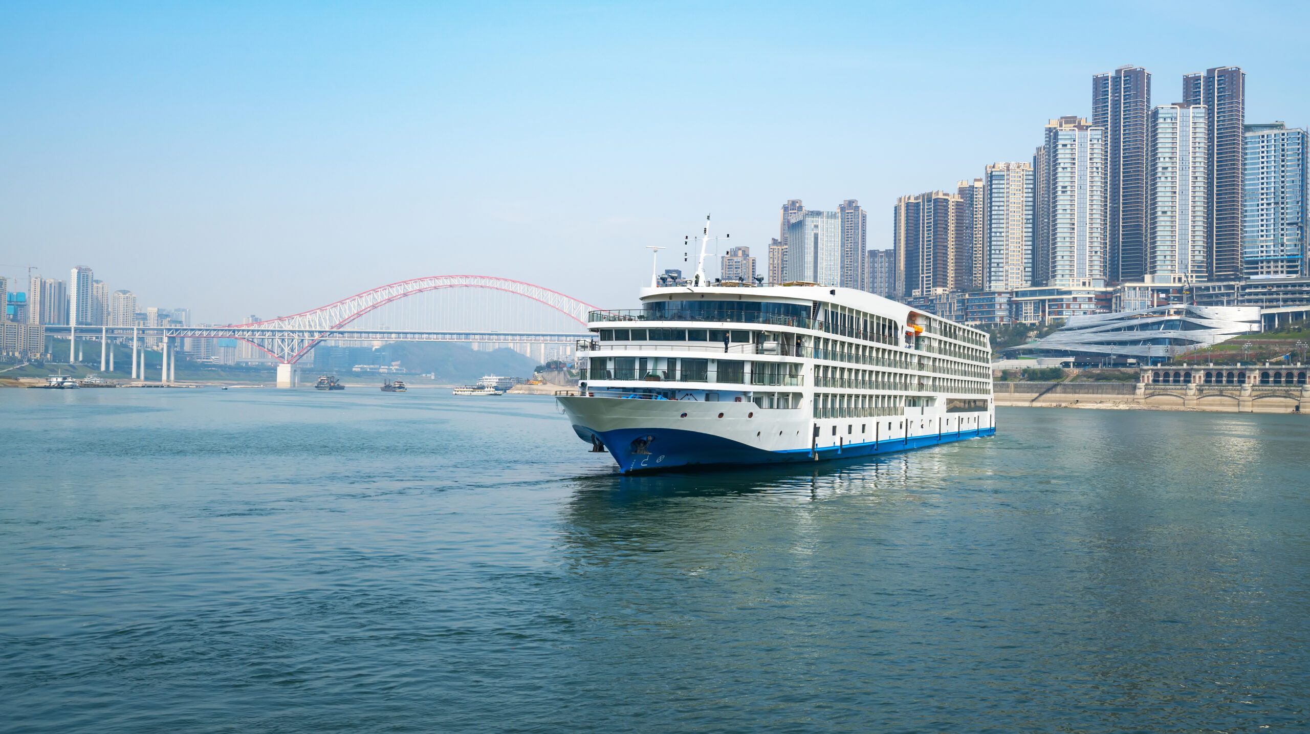 Luxury cruise ships sailing on the Yangtze River, the city skyline in Chongqing, China