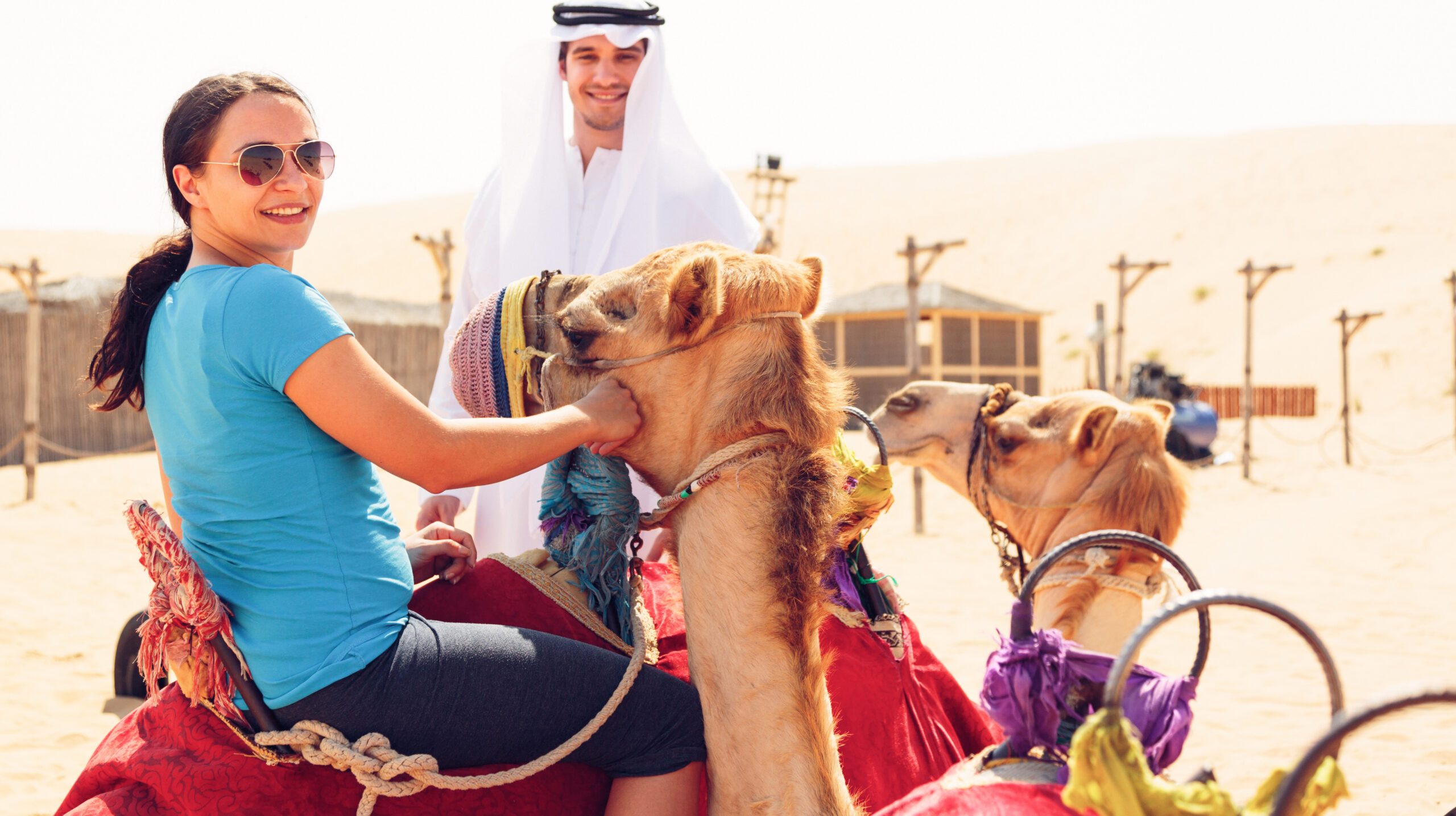 man-looking-woman-sitting-camel