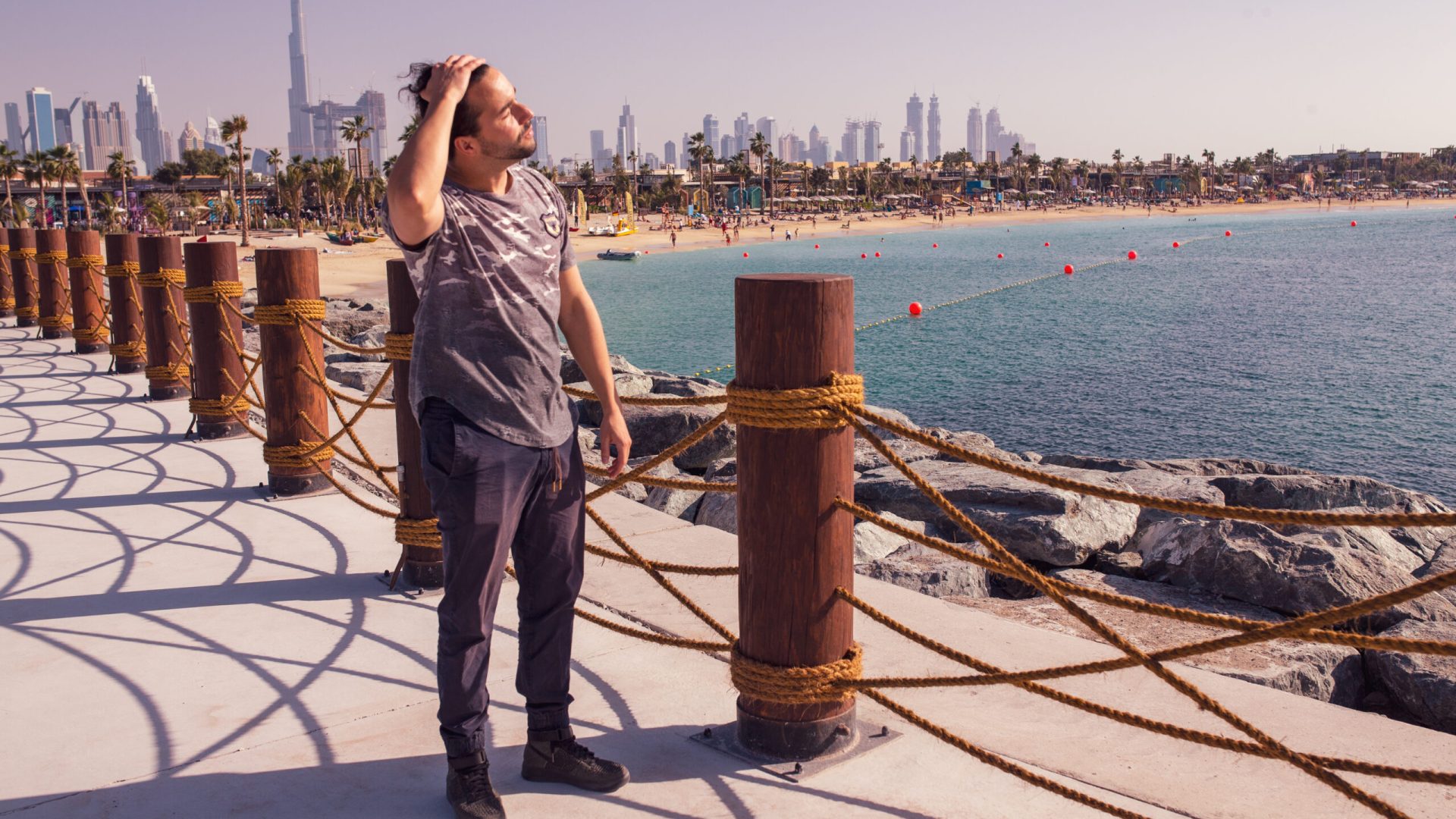 man-standing-by-railing-sea-against-sky