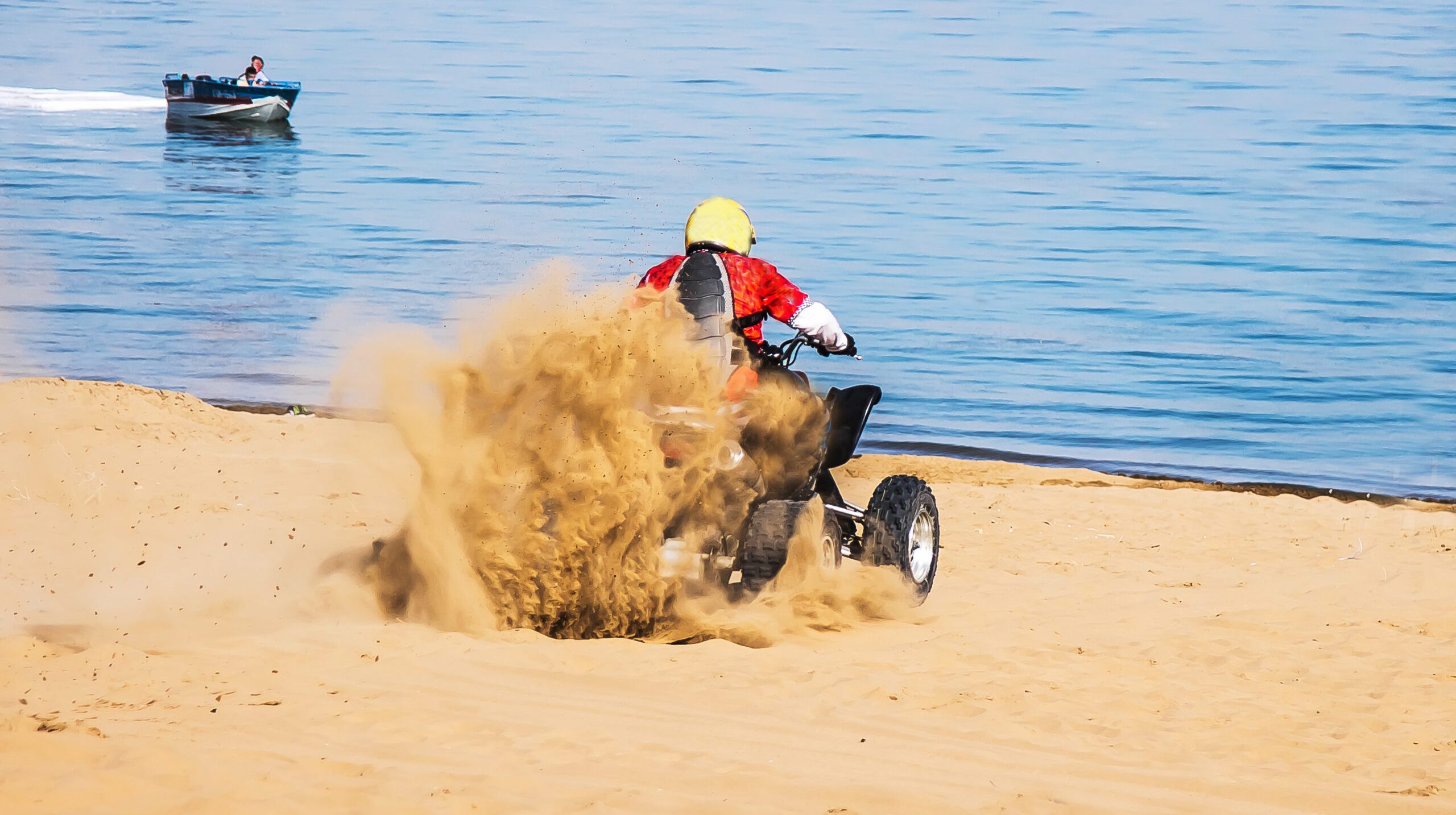 Motorcyclist on a quad on a sandy beach