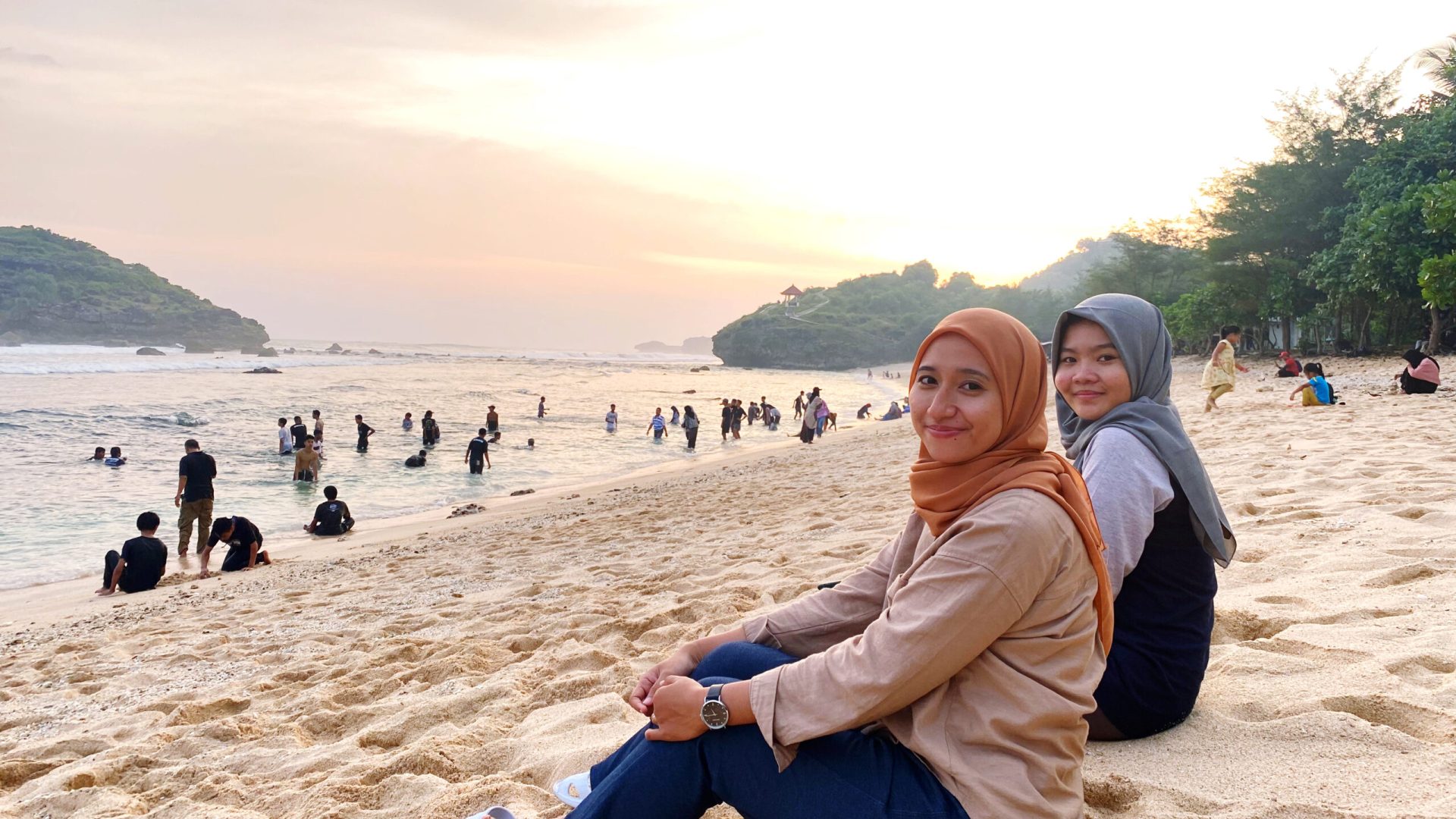 portrait-woman-sitting-beach-against-sky
