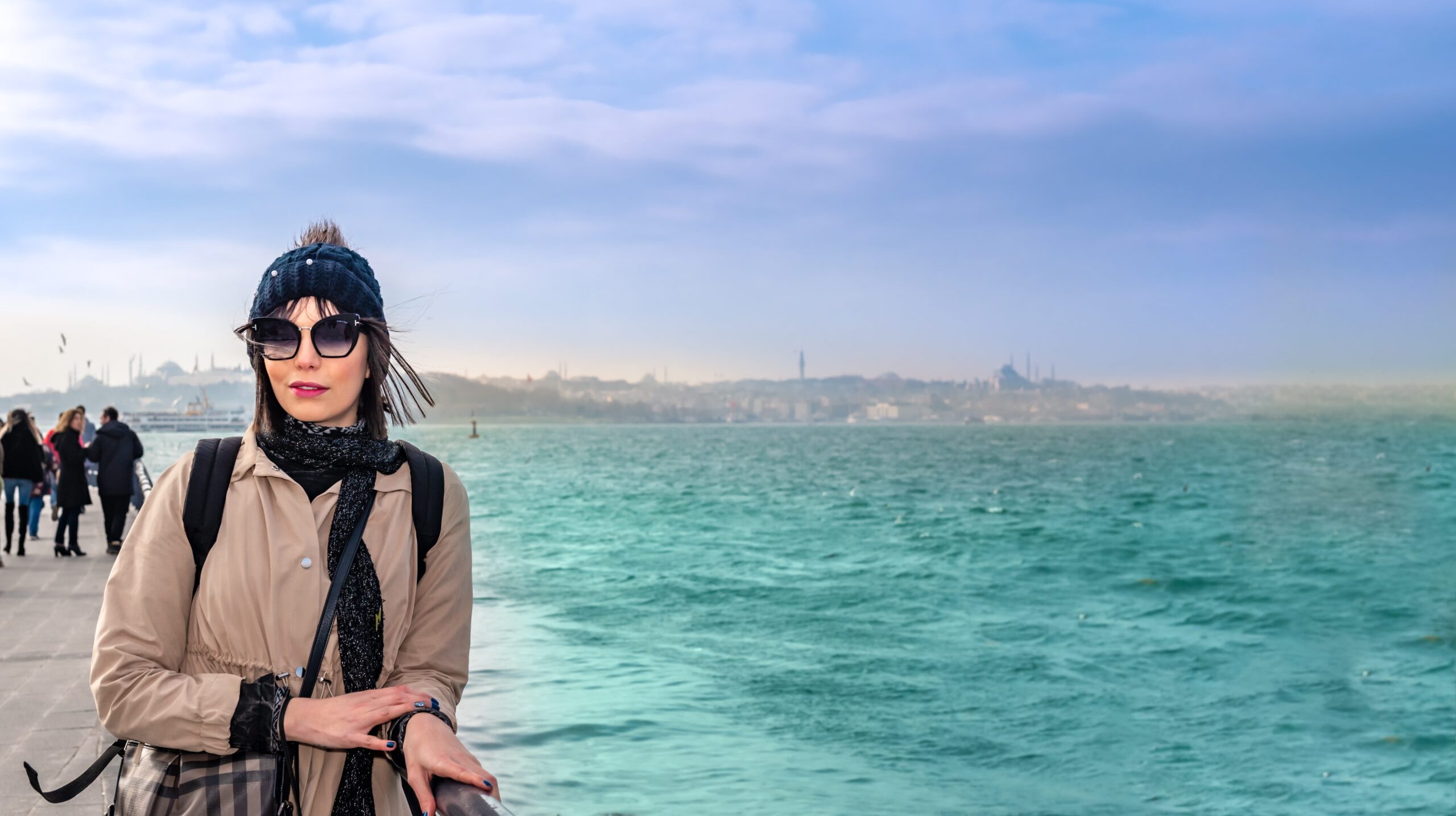 Beautiful woman traveler poses in front of Bosphorus,a popular destination in Uskudar,Istanbul,Turkey