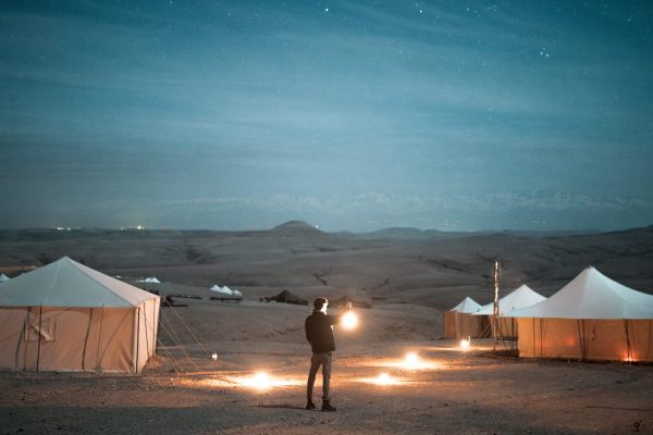 rear-view-man-holding-illuminated-lamp-against-tests-scaled-rh3pqg44mi5evymklgric2yttne1rm655w0ofjq7lw