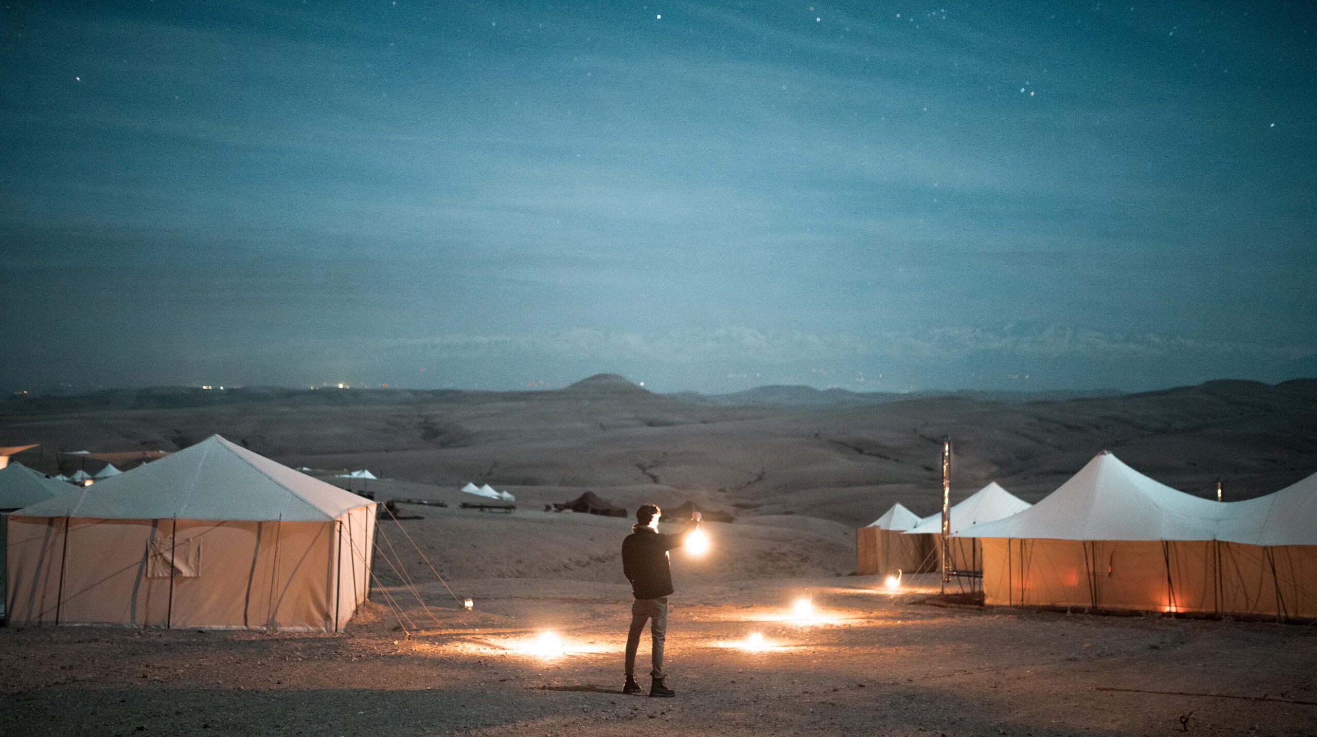 rear-view-man-holding-illuminated-lamp-against-tests