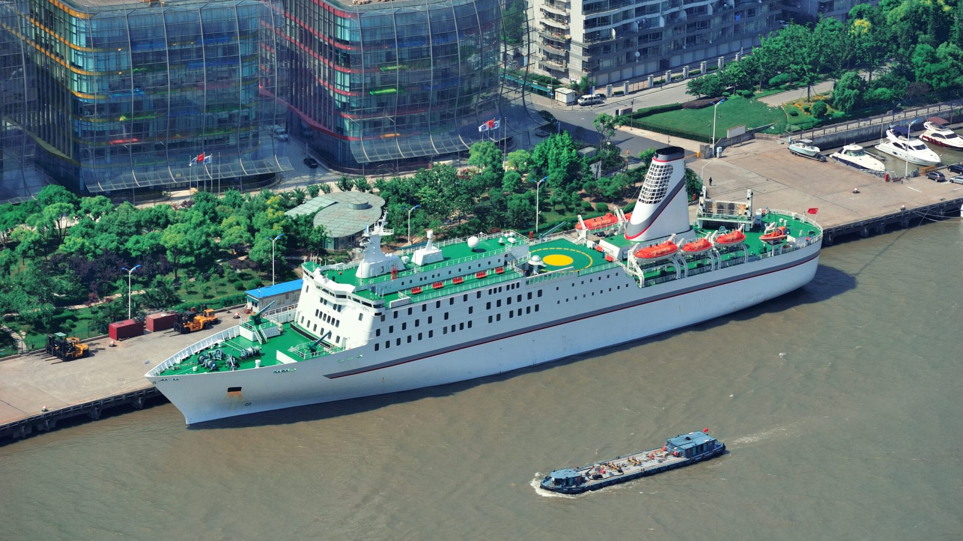 Shanghai city aerial view with urban architecture over river and blue sky in the day.