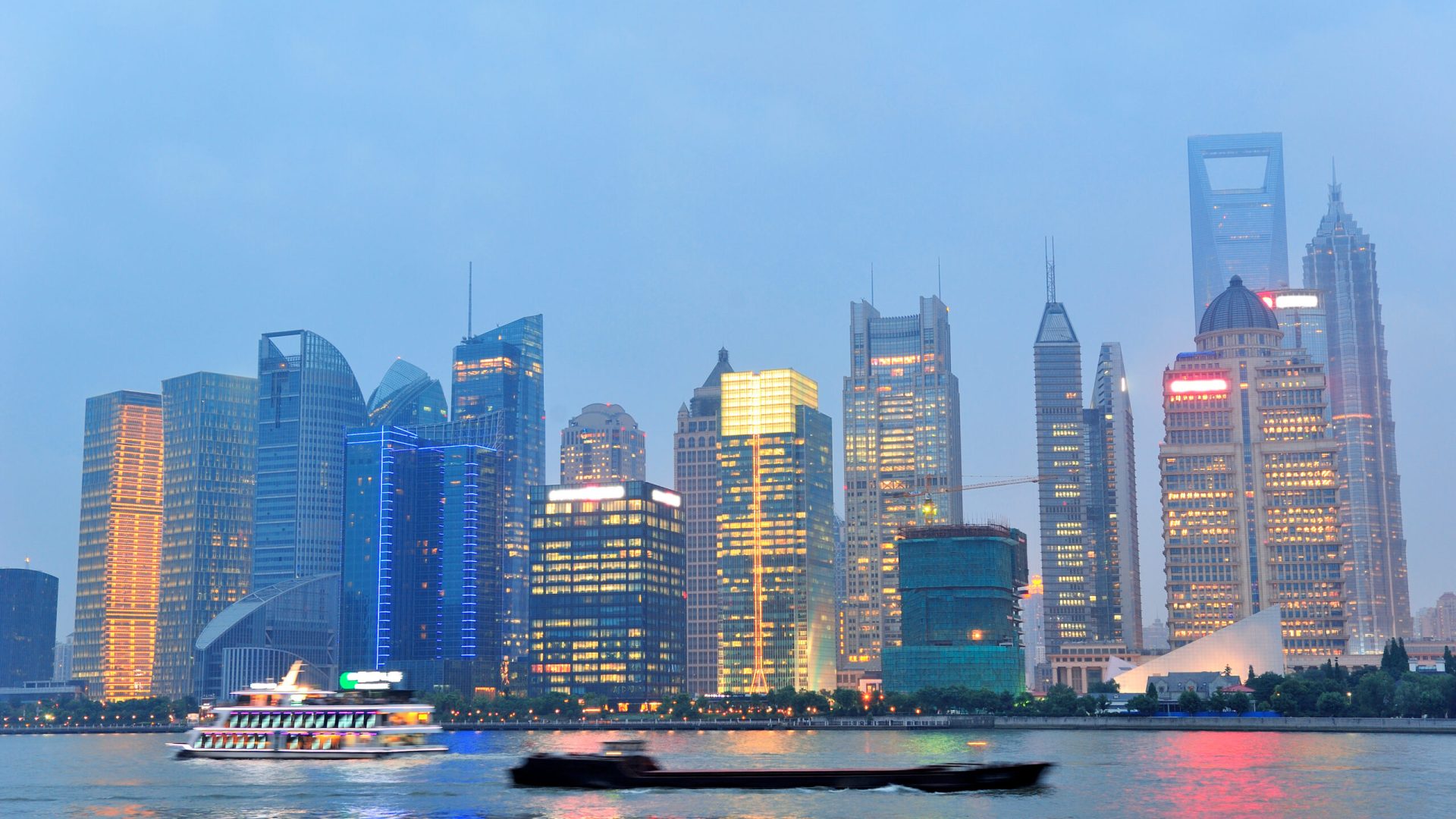 Shanghai urban architecture over river at dusk