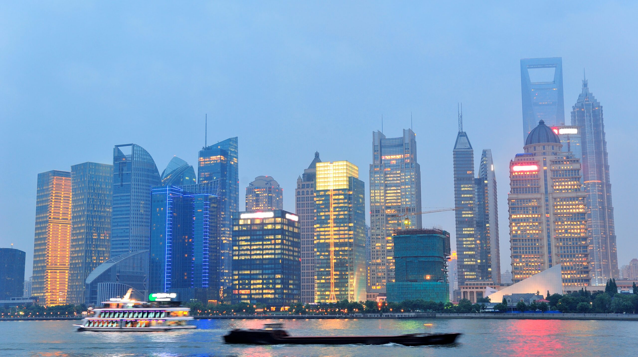 Shanghai urban architecture over river at dusk