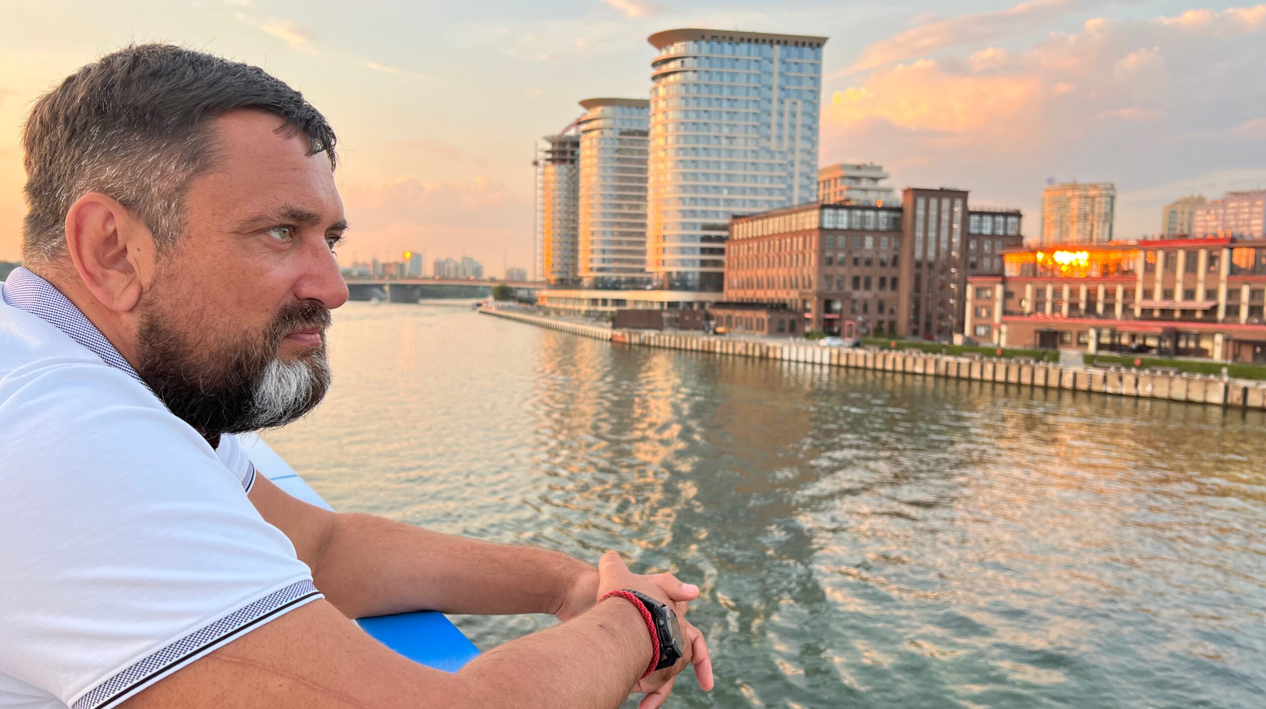 side-view-man-looking-river-against-sky-sunset
