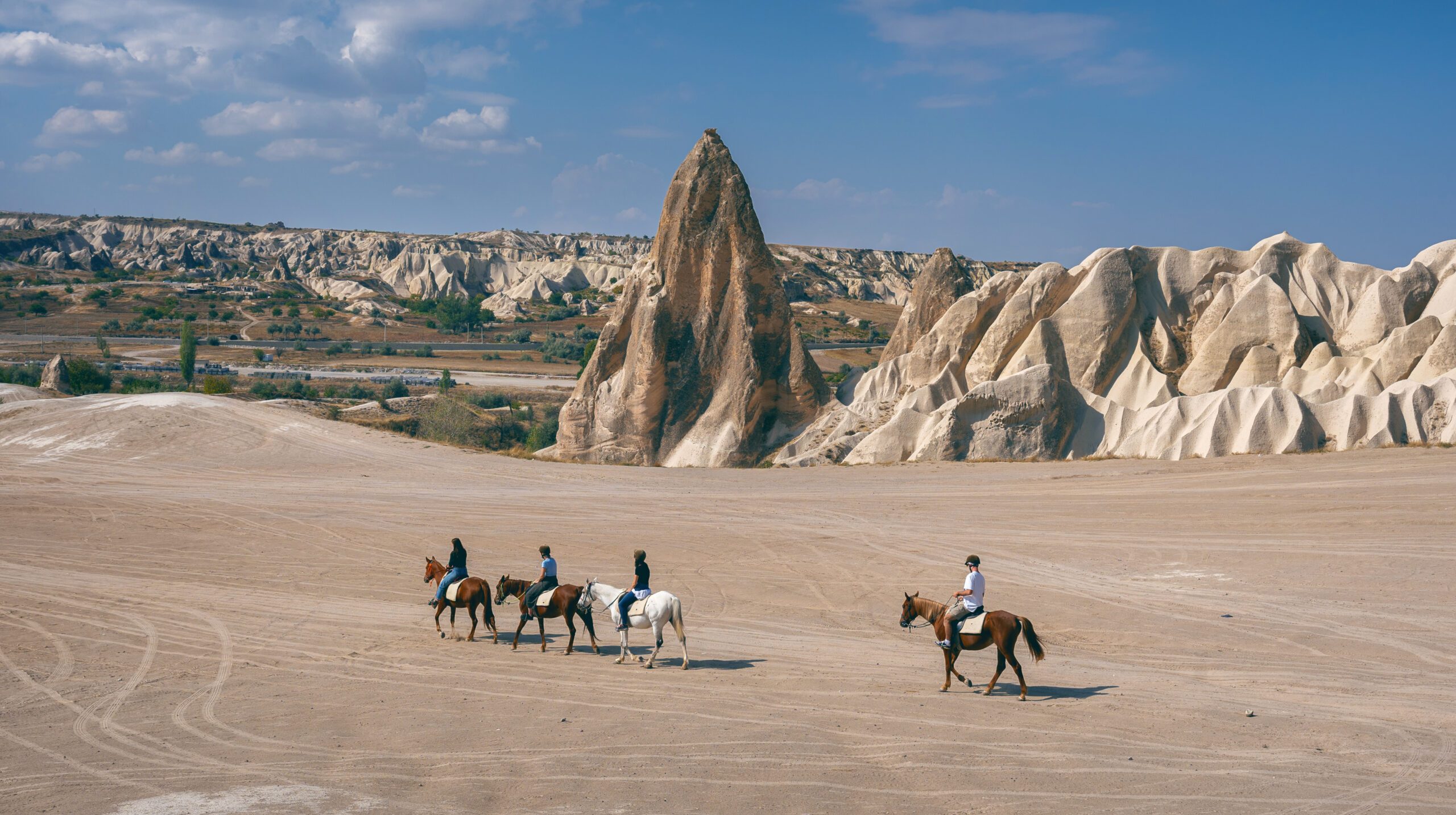 Tourists enjoy ride horses in Cappadocia, Turkey