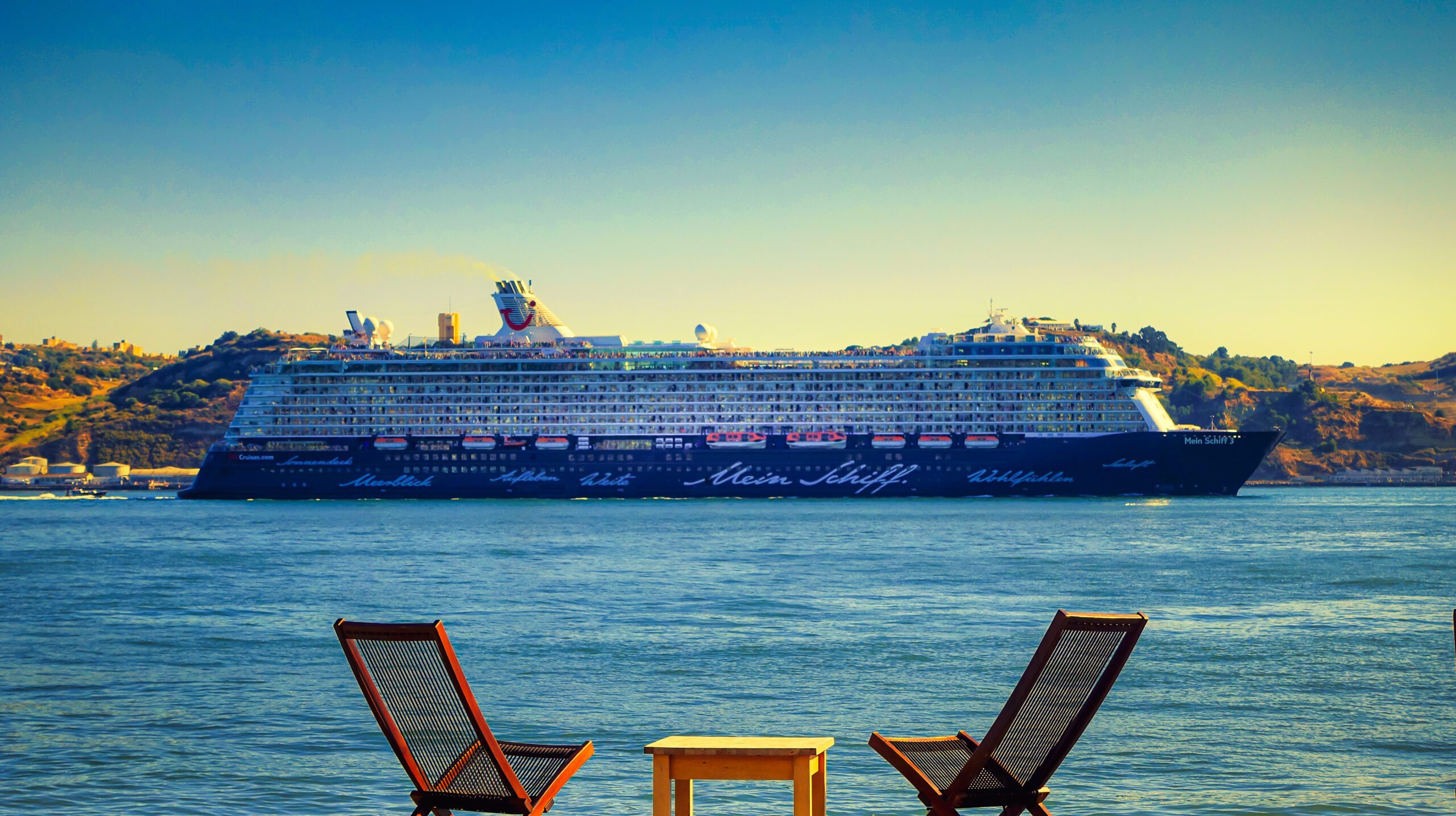 waterfront-view-cruise-ship-with-clear-sky-front-relaxing-chairs