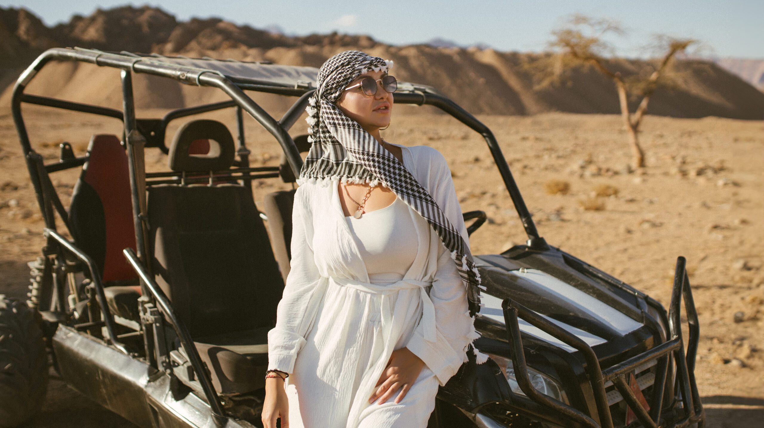 Woman tourist on quad bike ATV safari with desert background of Sharm El Sheikh Egypt.
