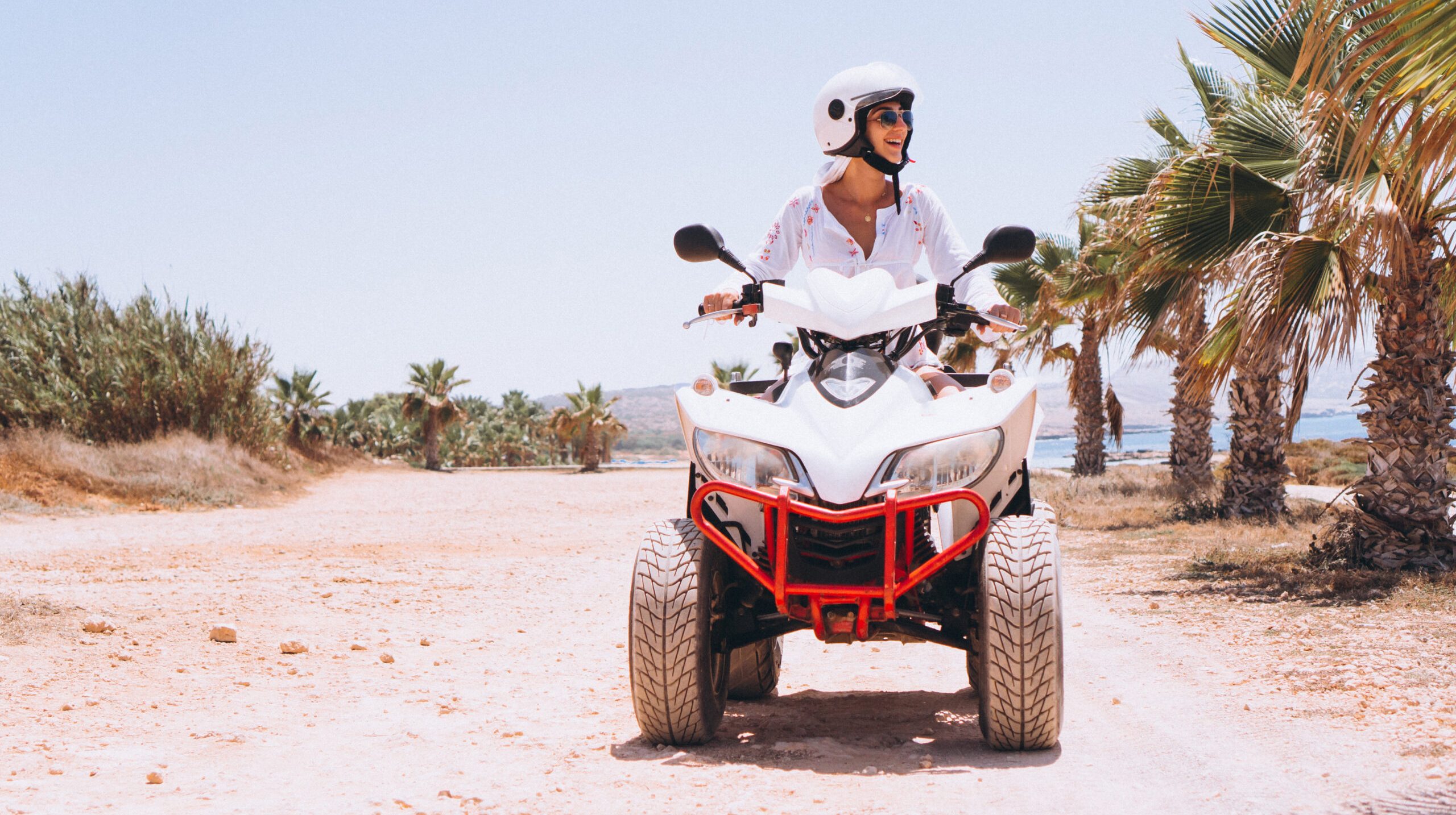 Woman travelling on quad by th ocean