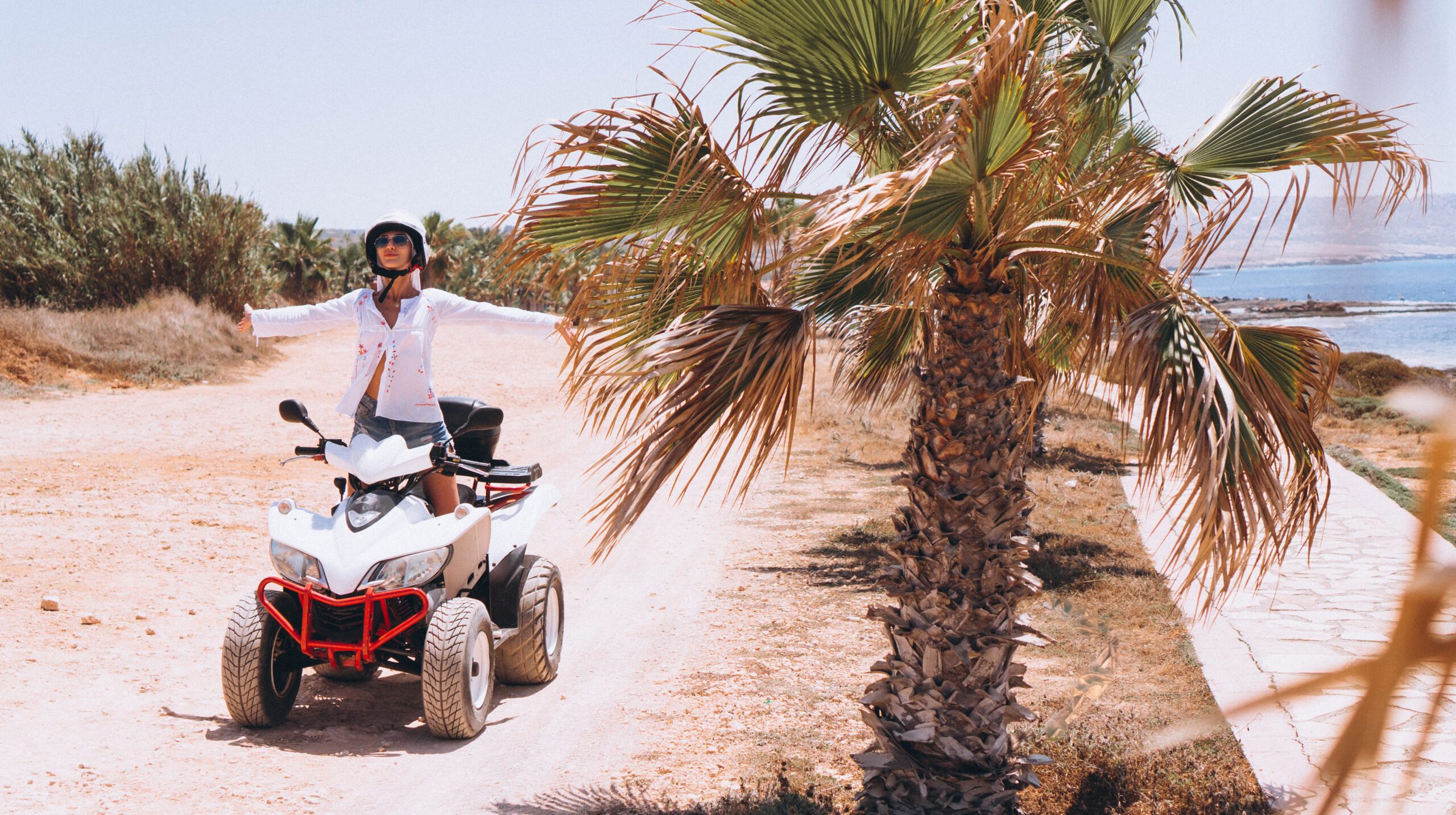 Woman travelling on quad by th ocean