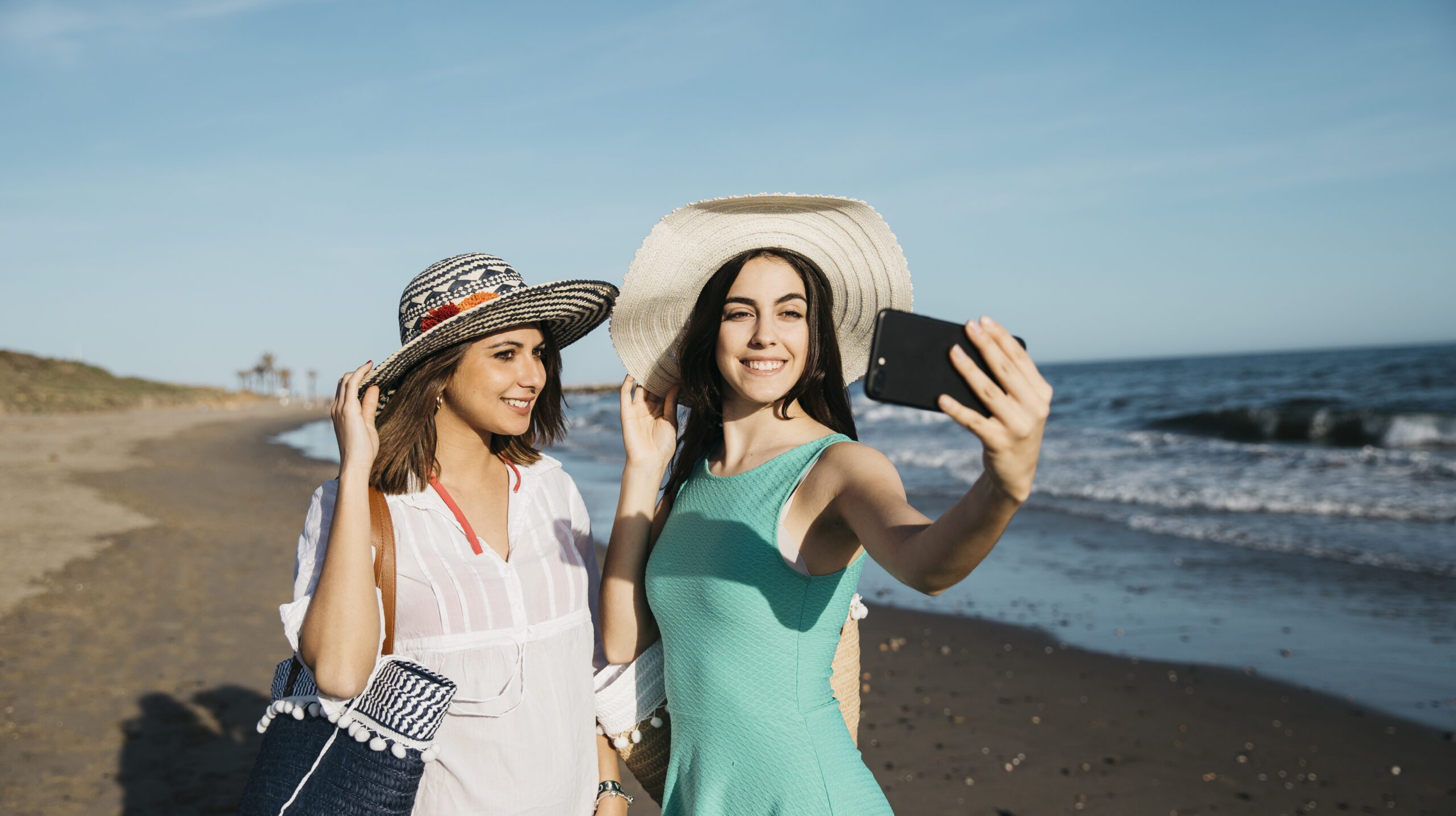 women-taking-selfie-beach
