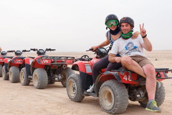 young-couple-riding-sand-atv-scaled-rhji9fc553wfi975tfgvkb7zlc9bfknmg0z25d4v7o