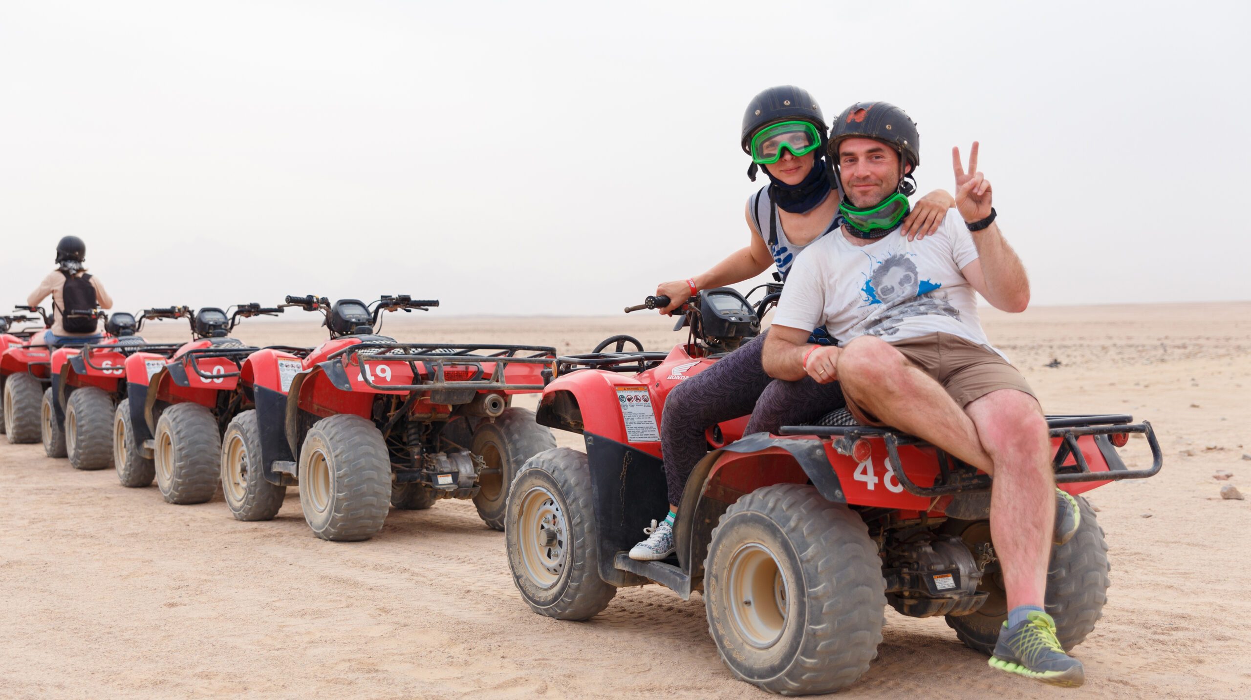 HURGHADA, EGYPT - MAY 18, 2015: Young couple riding sand ATV and having fun