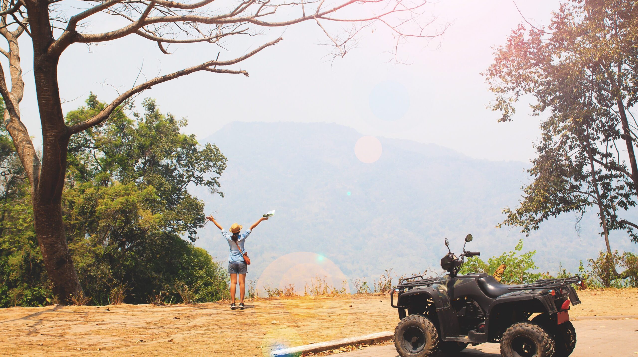 Young happy traveler with hill landscape